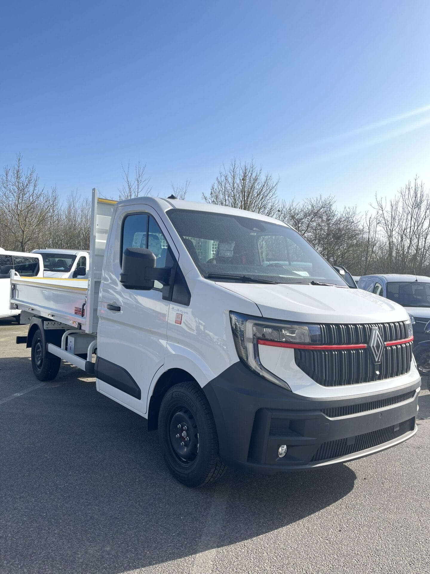 White flatbed truck parked outdoors