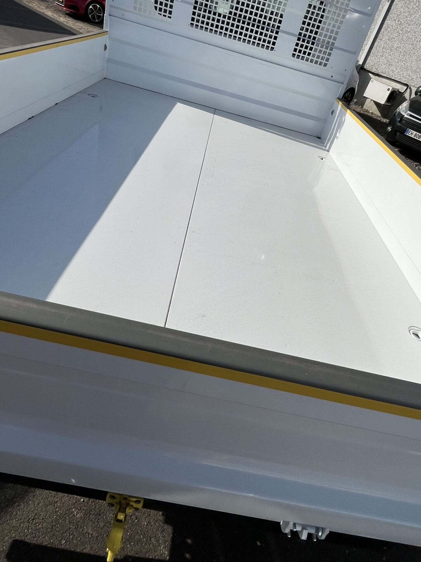 Empty white truck bed in sunlight