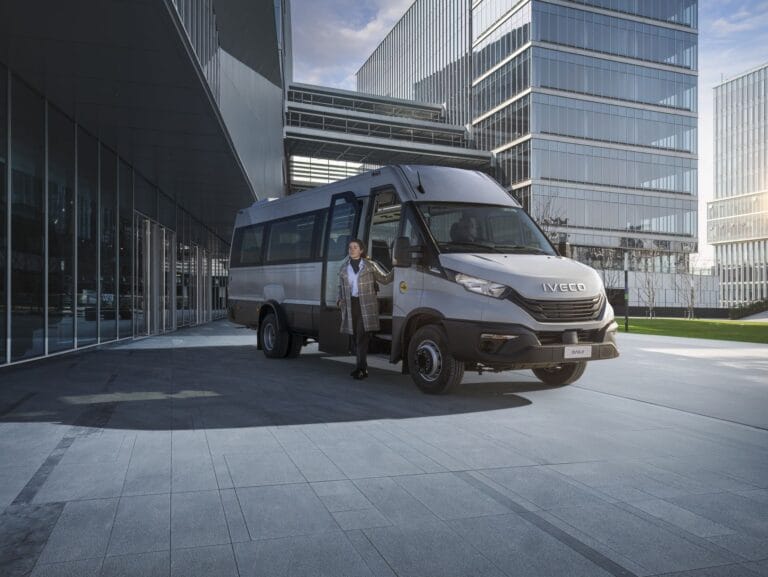 Minibus Iveco Daily devant immeubles modernes