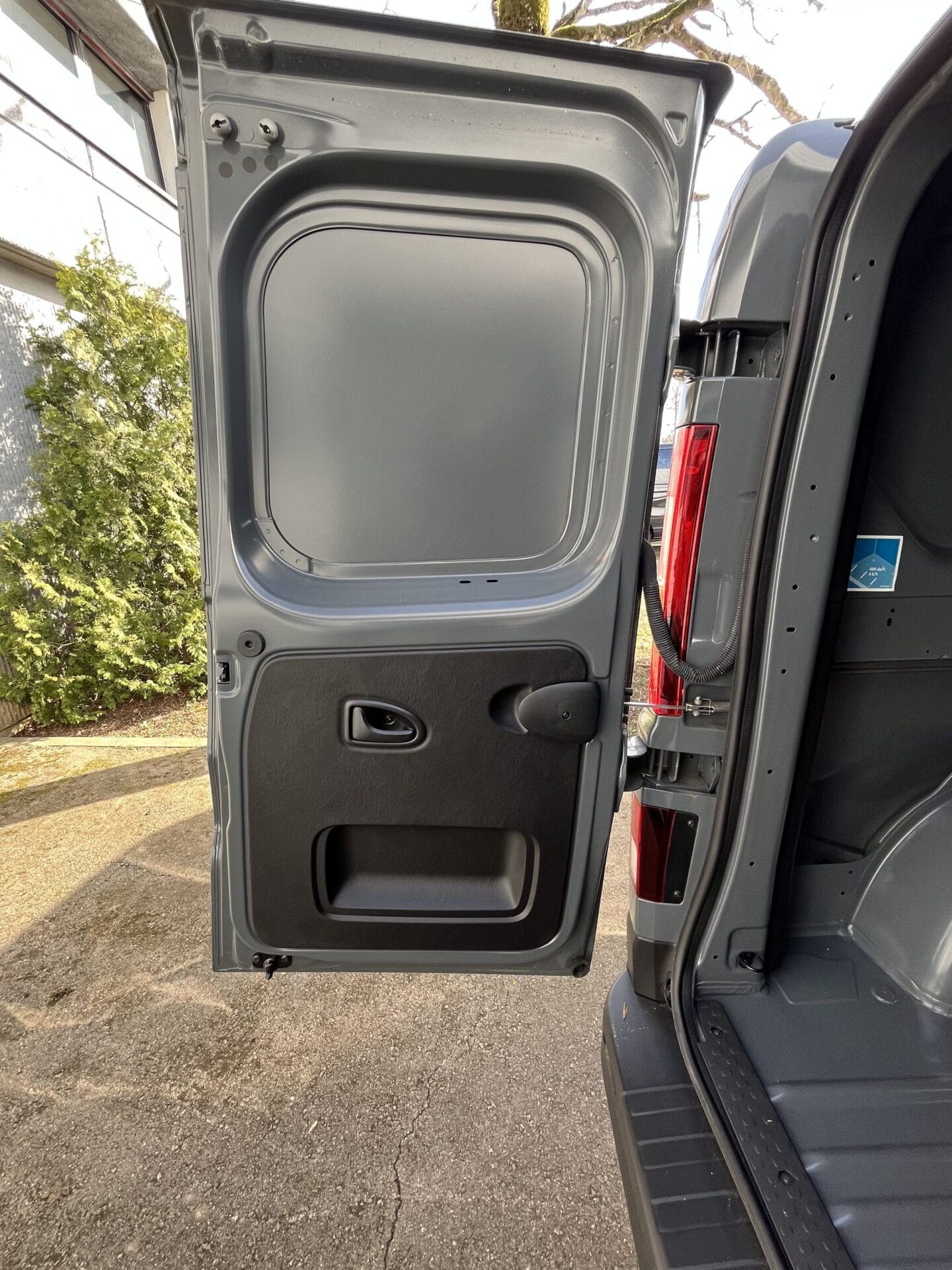 Open rear door of a gray van
