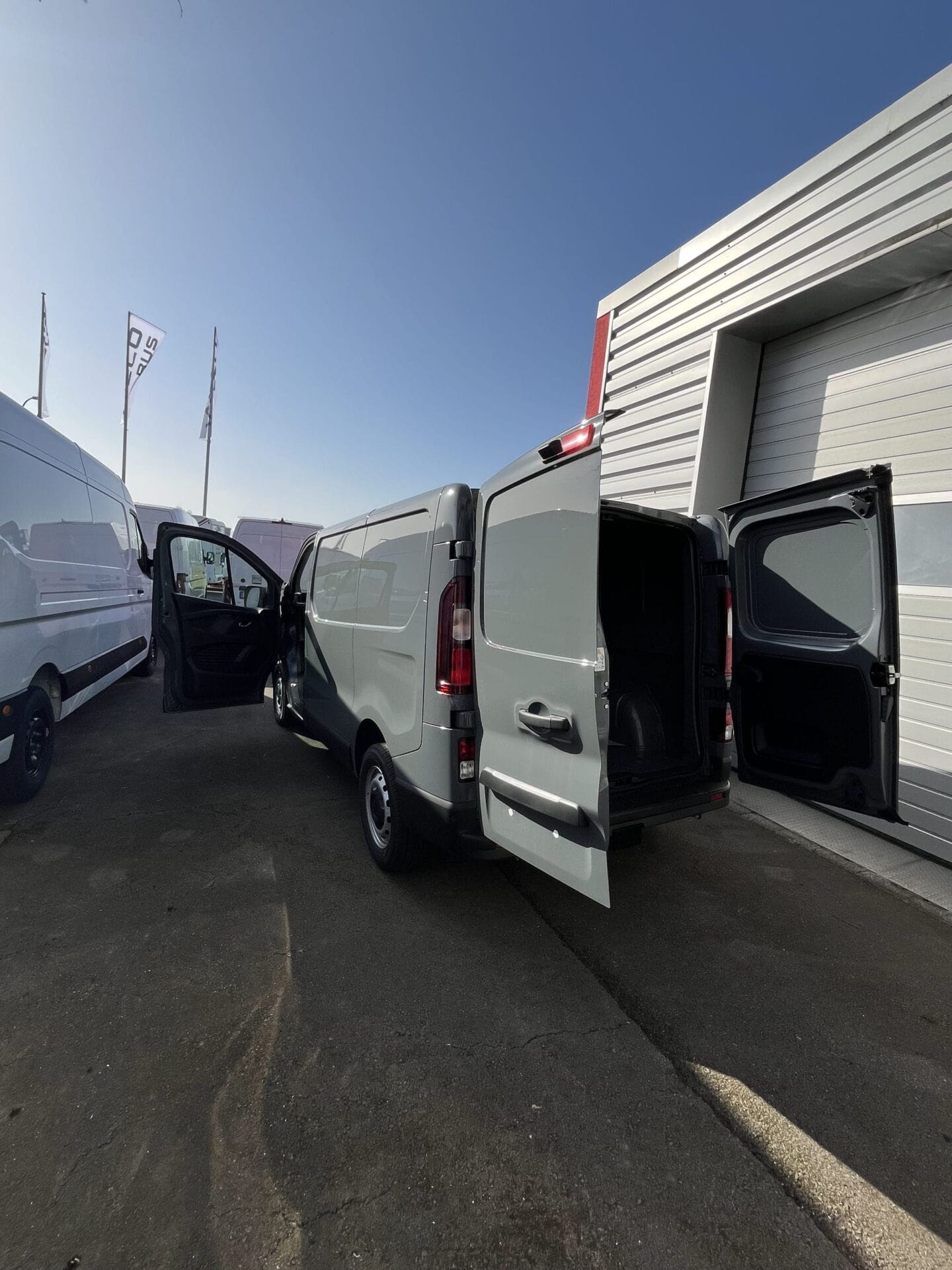 Open gray cargo van in parking lot
