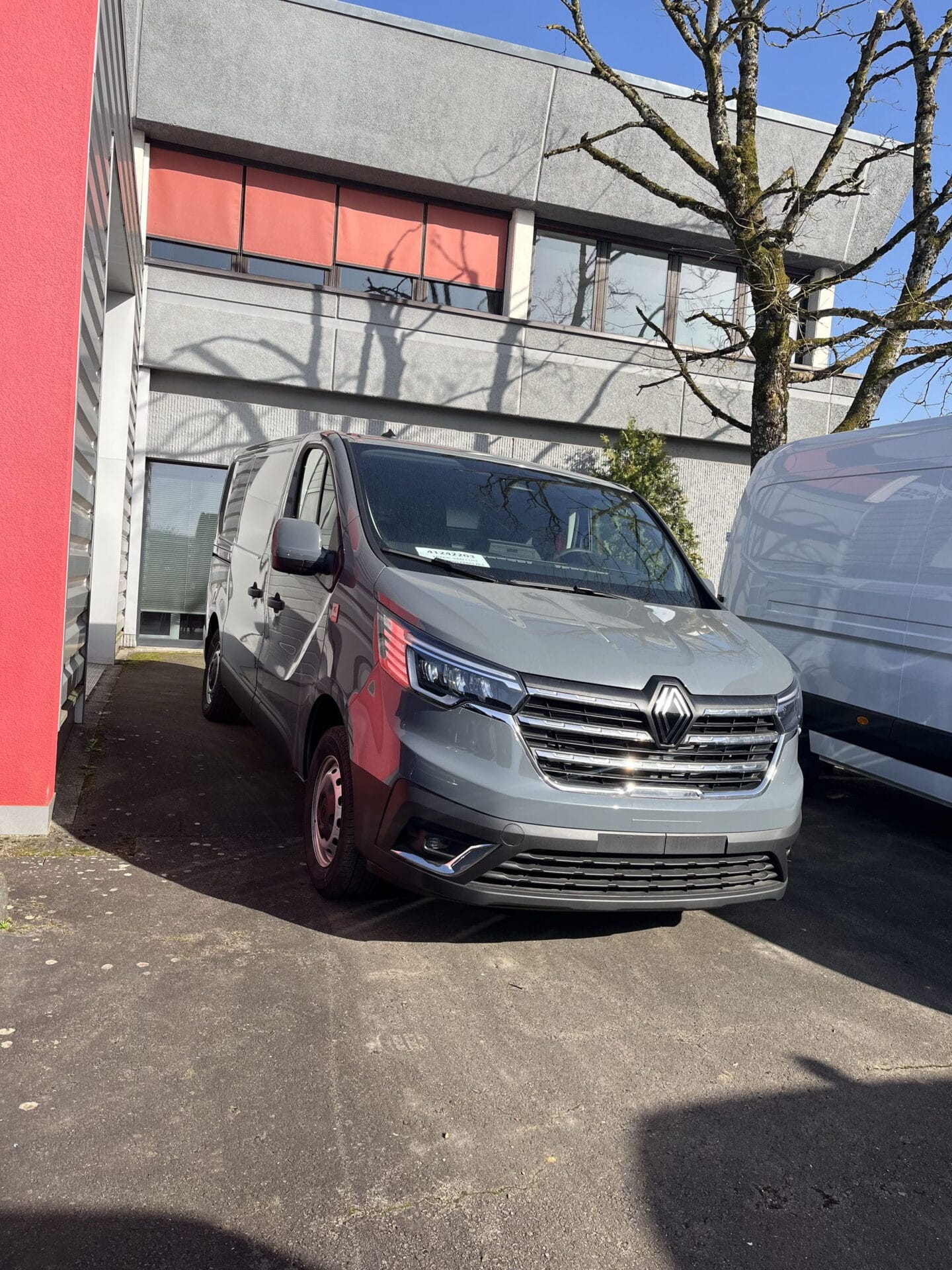 Gray van parked near a building